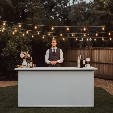 Wedding barback supporting bartending service by restocking ice and glassware for faster drink service